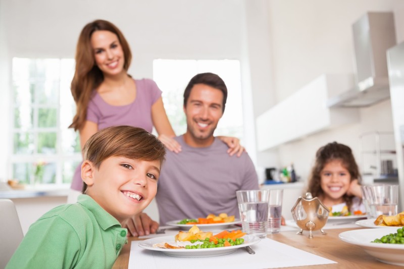 18122452 - family looking at the camera at dinner time in kitchen