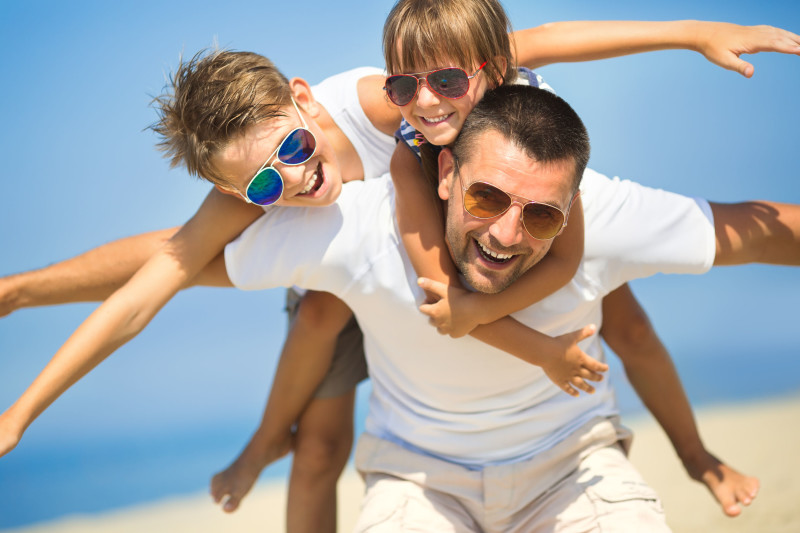 46796005 - father with children having fun on the beach at the day time.