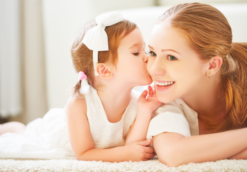 48882678 - happy family.  little child girl kisses her mom